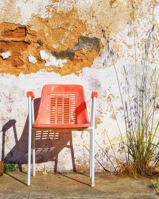 Plastic chair against old wall
